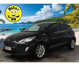 1,0 ECOBOOST 95HV M6 TITANIUM 5-OVINE * LOHKO / RATINLÄMMITIN / LÄMMITETTÄVÄ TUULILASI / KAISTAVAHTI / MERKKIHUOLLOT *