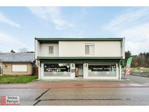Handelspand met bovenliggend appartement en achterliggende bouwgrond.