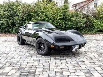 corvette c3 black with a beige leather interior.