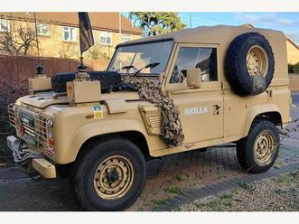 a rare opportunity to own a land rover 90 wolf replica, finished in striking desert camouflage with whip aerials for that authentic military look.
